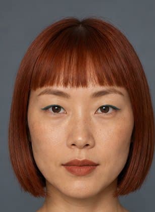 Suki, from Fun Guy's cast: a woman with a copper-red bob and bangs